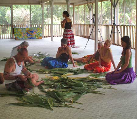 Kumu Hula Kawaikapuokalani Hewett teaching Hula Intensive <br>students to make a ti leaf skirt